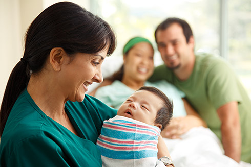 Nurse holding newborn